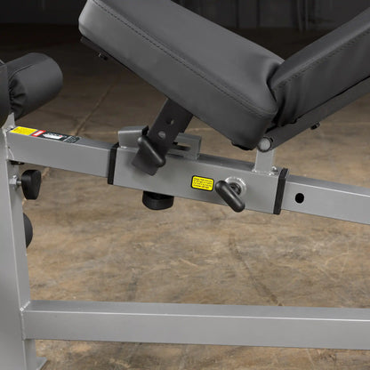 Adjustable weight bench with black cushion and silver frame, featuring a secure locking mechanism.