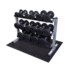 Rubber dumbbells on a three-tier rack, featuring weights from 5 to 30 pounds.