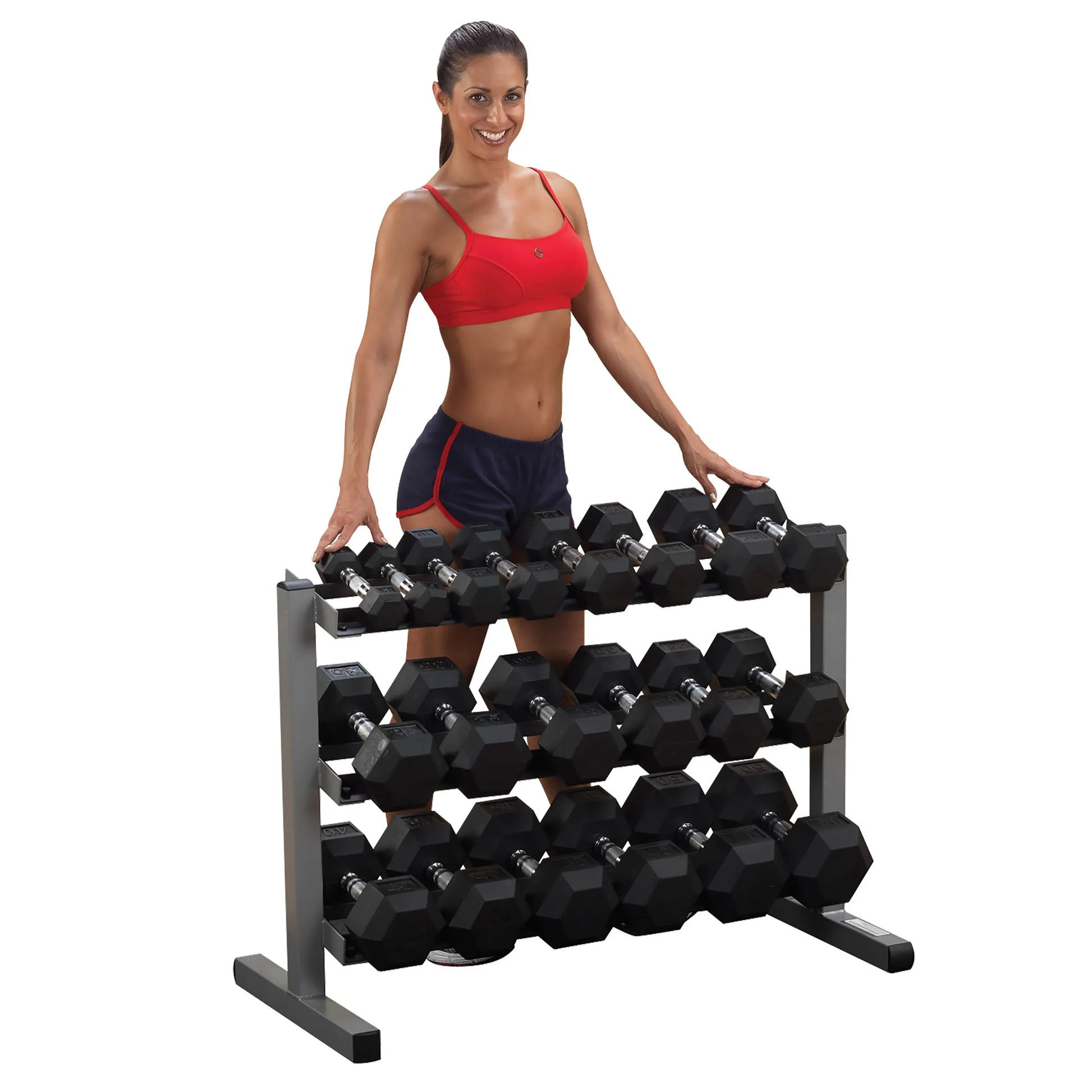 Woman in red top with a dumbbell rack, featuring hexagonal weights, ideal for home gym setups.