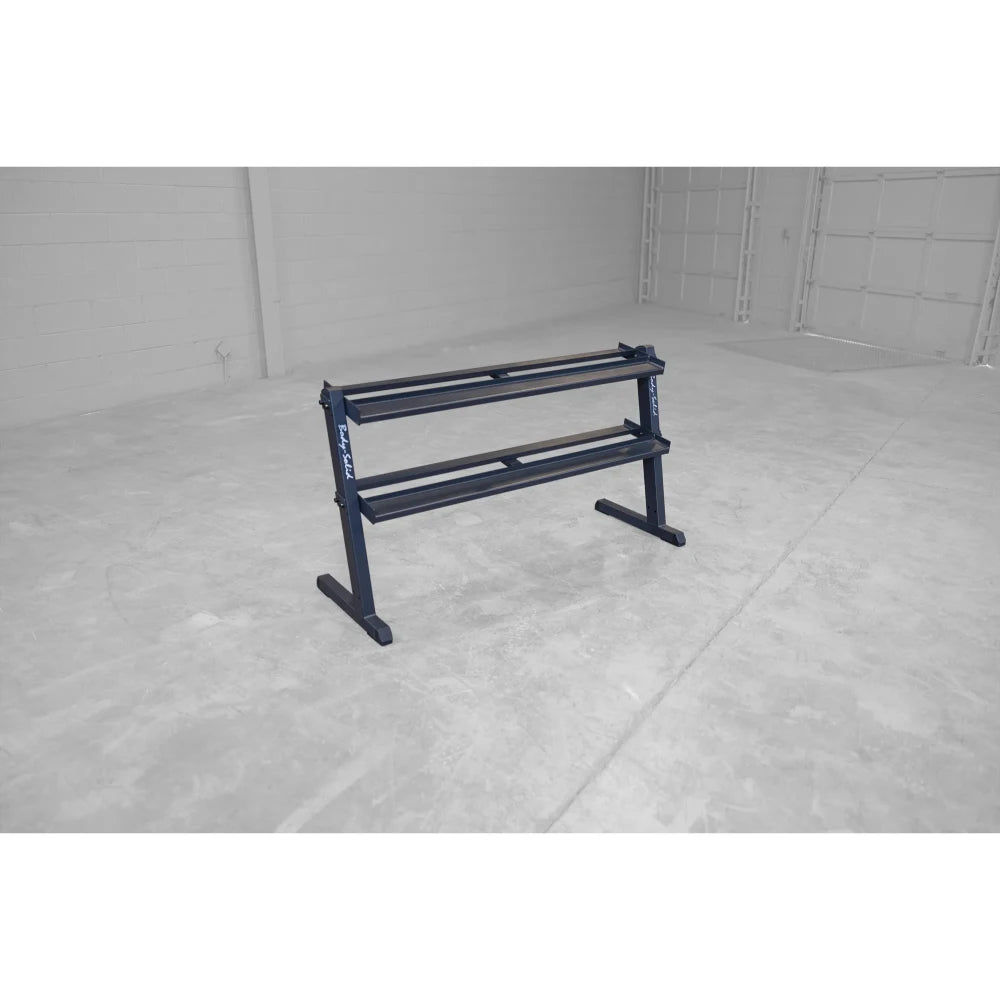 Steel dumbbell rack with two tiers in a spacious, empty gym.
