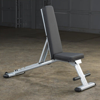 Adjustable weight bench with black padding in a gym setting.