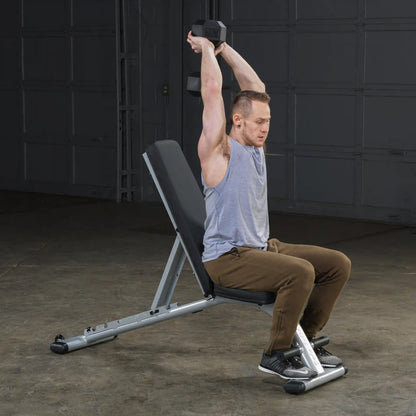 Man performing seated dumbbell tricep extension on adjustable weight bench.