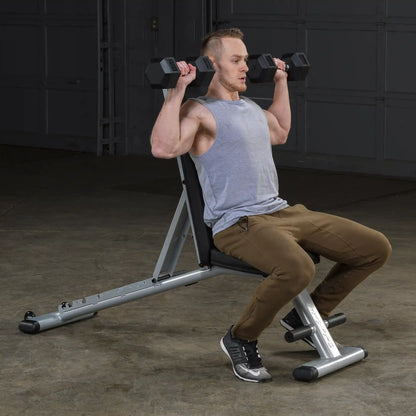 Man performing shoulder press on a Bowflex adjustable weight bench.