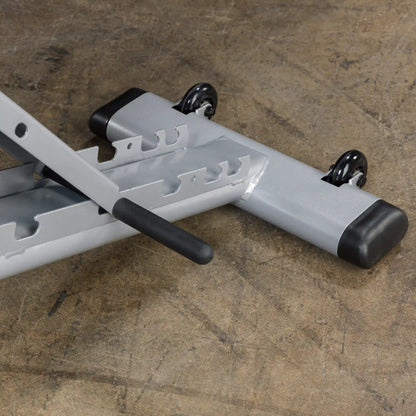 Adjustable weight bench frame with wheels on concrete floor.