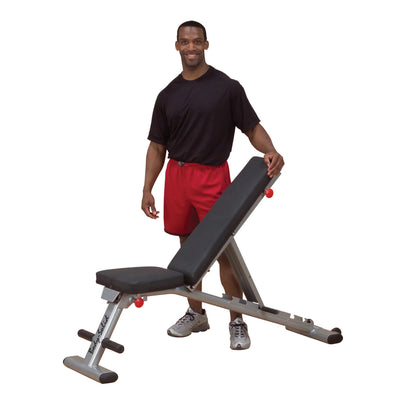 Man in red shorts with PowerBlock Sport Bench in adjustable position.