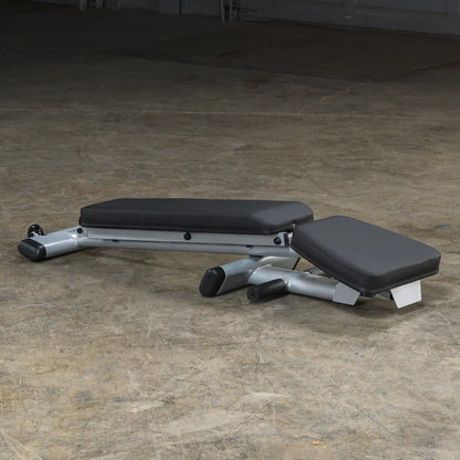 Adjustable weight bench with black padding on a concrete floor, ideal for home gym setups.