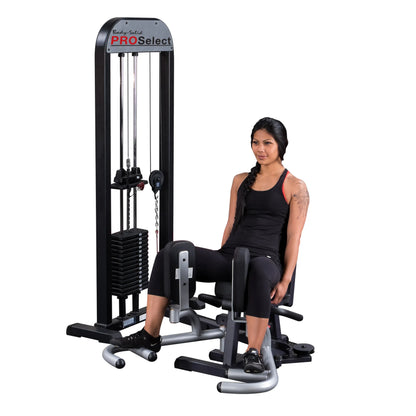 Woman using Body-Solid PRO Select inner thigh machine in black athletic wear.