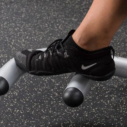 Black Nike training shoe on gym equipment, featuring breathable mesh design.