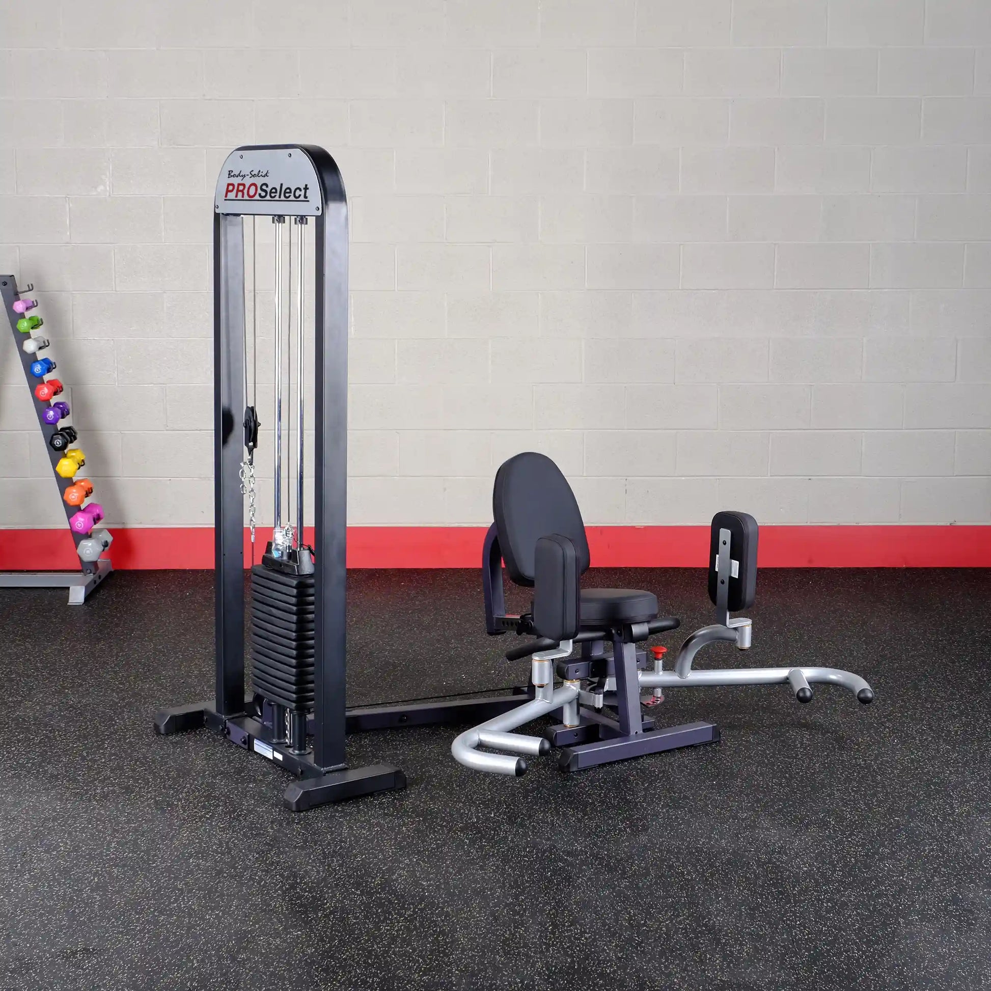 Body-Solid PRO Select leg press machine with black padding and weight stack in a gym setting.