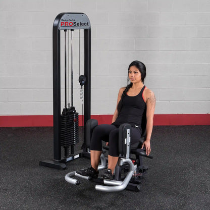 Woman using Body-Solid PRO Select Inner Thigh Machine in gym.