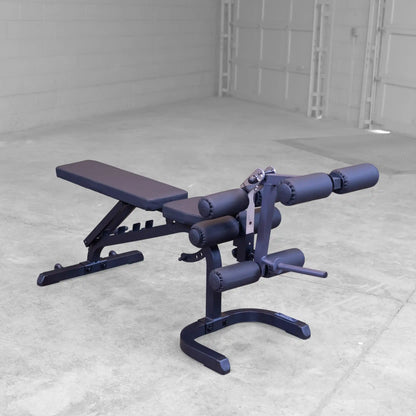 Adjustable weight bench with leg extension in a gray gym setting.