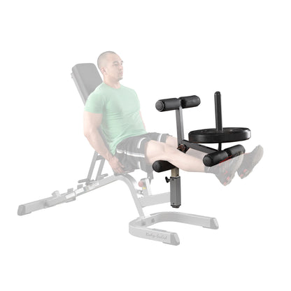 Body-Solid leg extension attachment with weight plates, designed for strength training on a home gym bench.