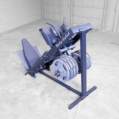Body-Solid leg press machine with weight plates in a gym setting.