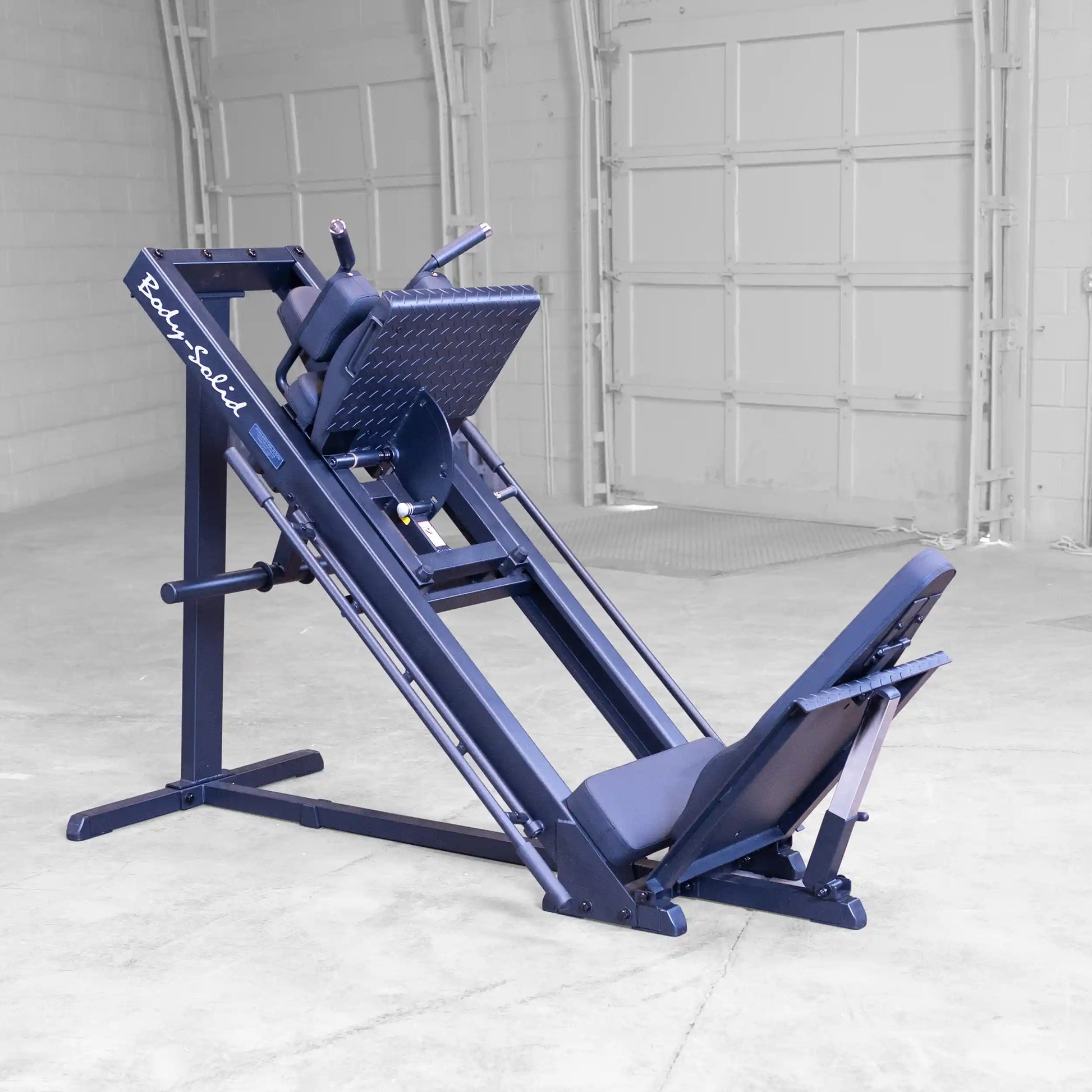 Body-Solid leg press machine in black with adjustable backrest in a gym setting.