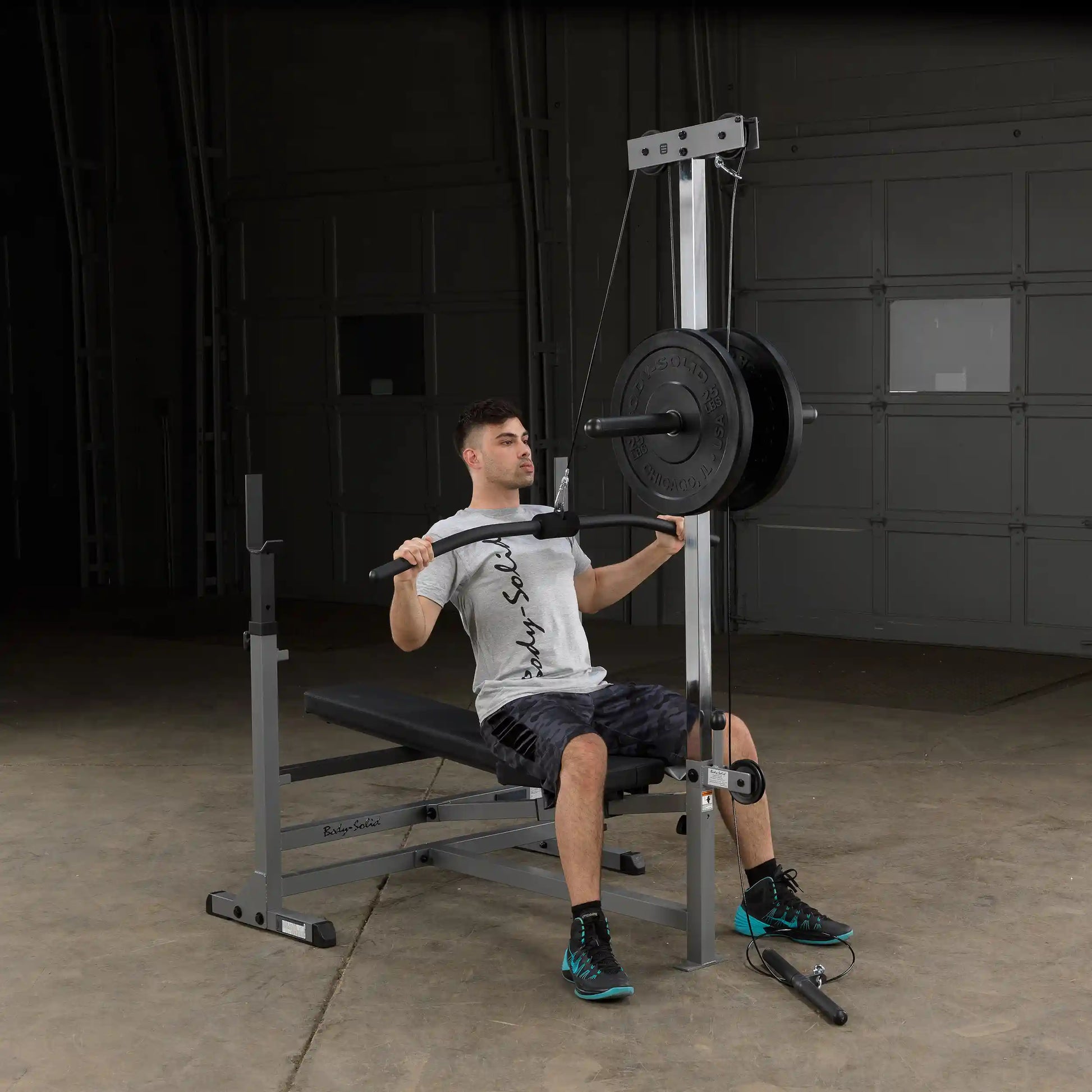 Man using Body-Solid Powerline home gym with weight stack for strength training.