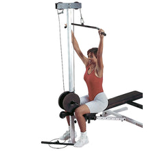 Woman using Body Solid lat pulldown machine with weights, wearing red top and gray shorts.