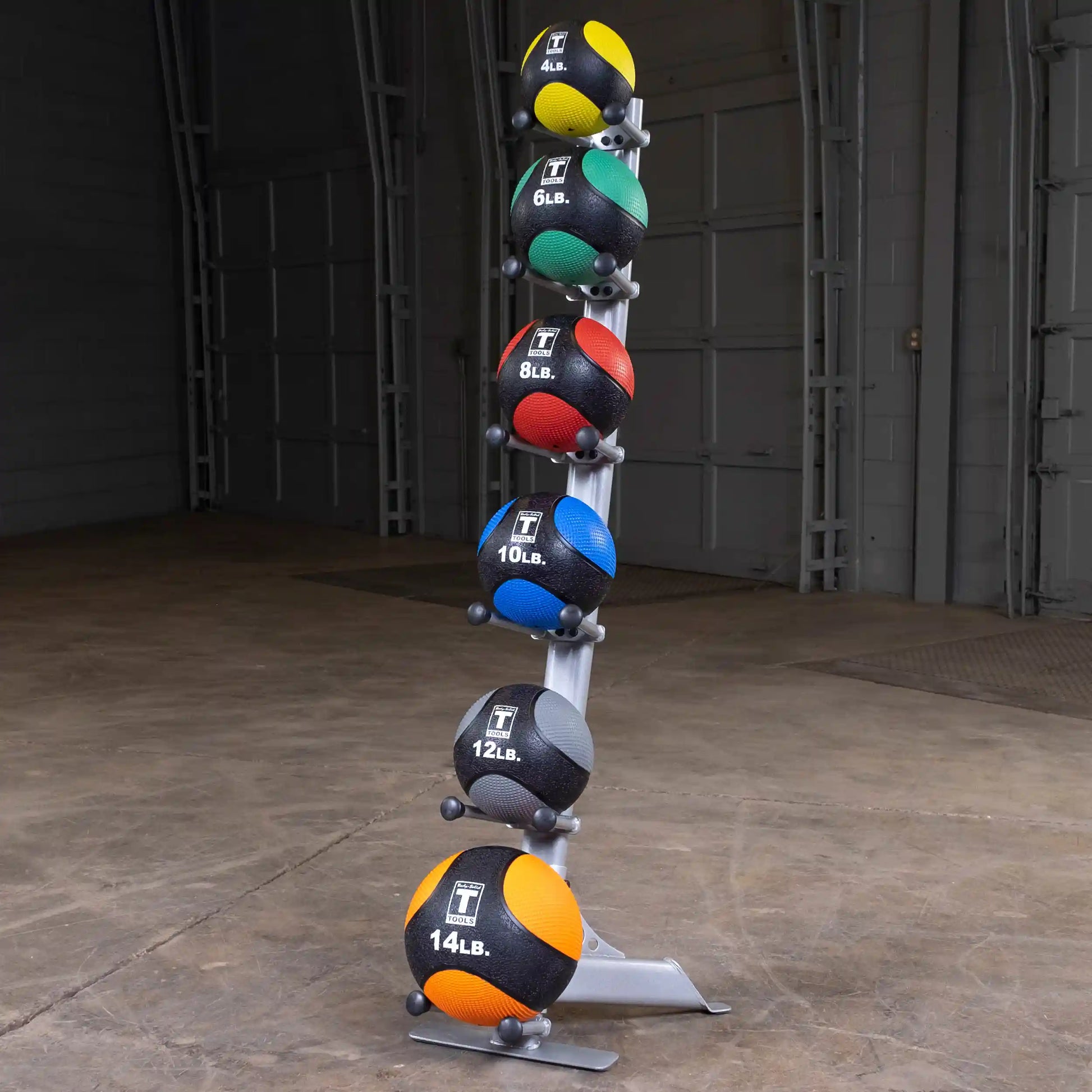 Medicine balls on rack, various weights and colors, perfect for gym workouts.