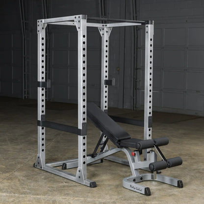 Body-Solid power rack with adjustable bench in a grey garage gym.