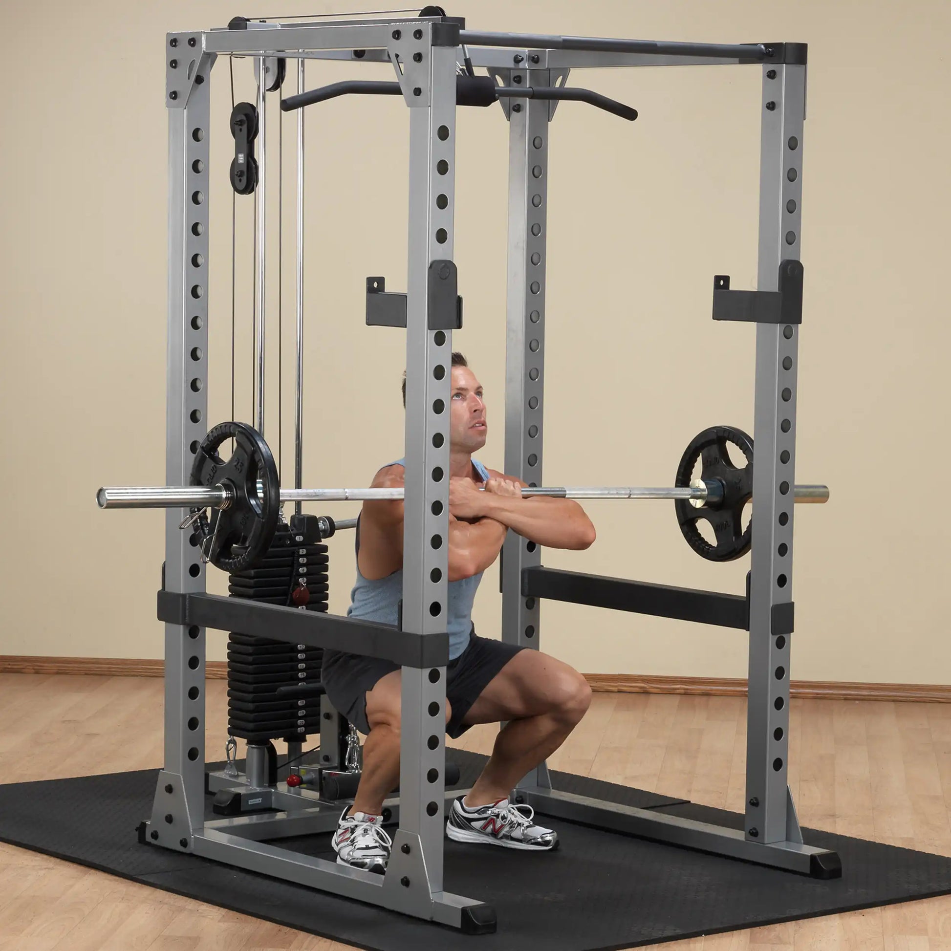 Man performing a front squat on a Smith machine with a silver barbell in a home gym.