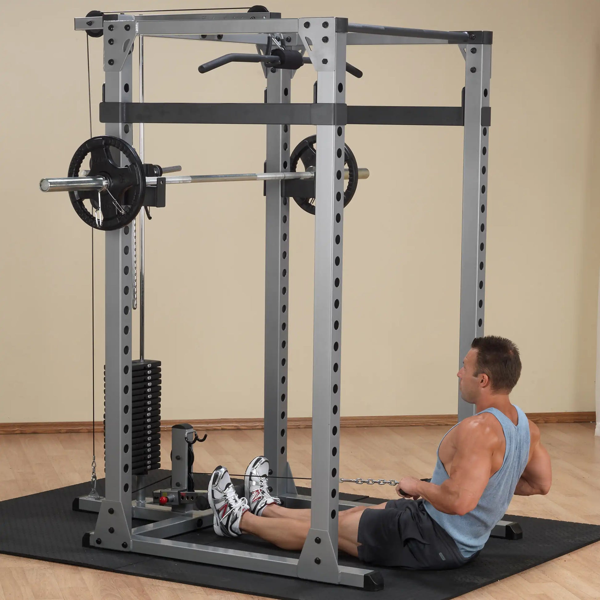 Man using a Smith machine for seated rows in a home gym.