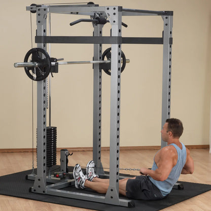Man using a Smith machine for seated rows in a home gym.