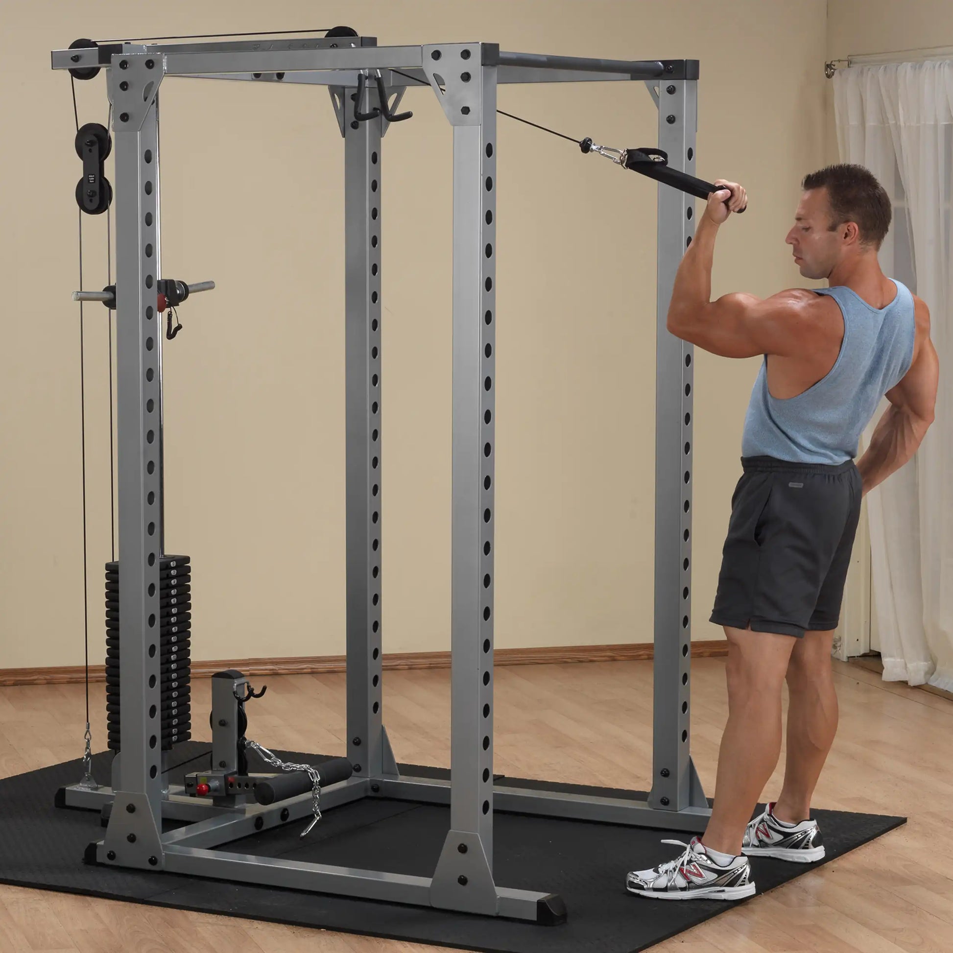 Man using Powerline Cable Crossover Machine for upper body workout in home gym.