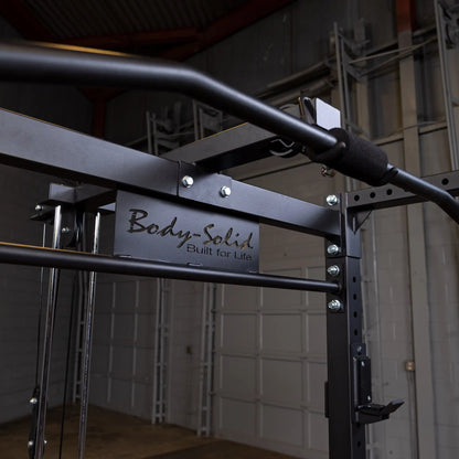 Body-Solid power rack with black steel frame in a gym setting.