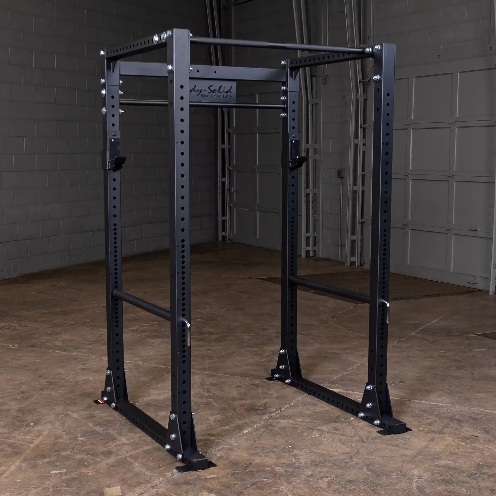 Body-Solid power rack in black steel, ideal for home gym weightlifting.