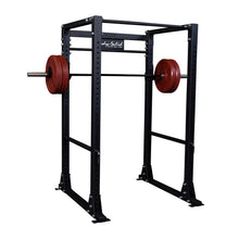Body-Solid power rack with red weight plates for strength training.