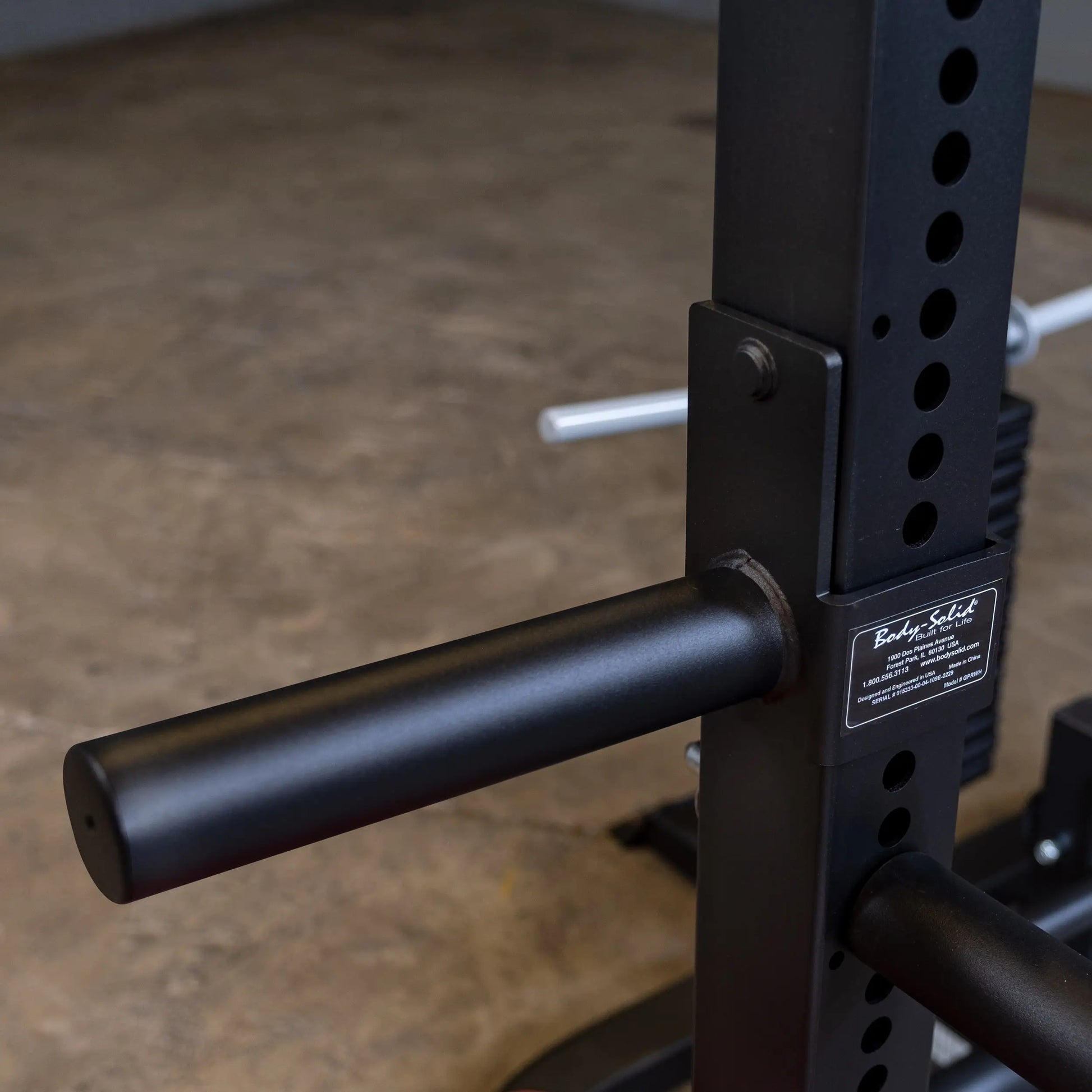 Body-Solid weight rack with adjustable black steel pegs for home gym equipment.