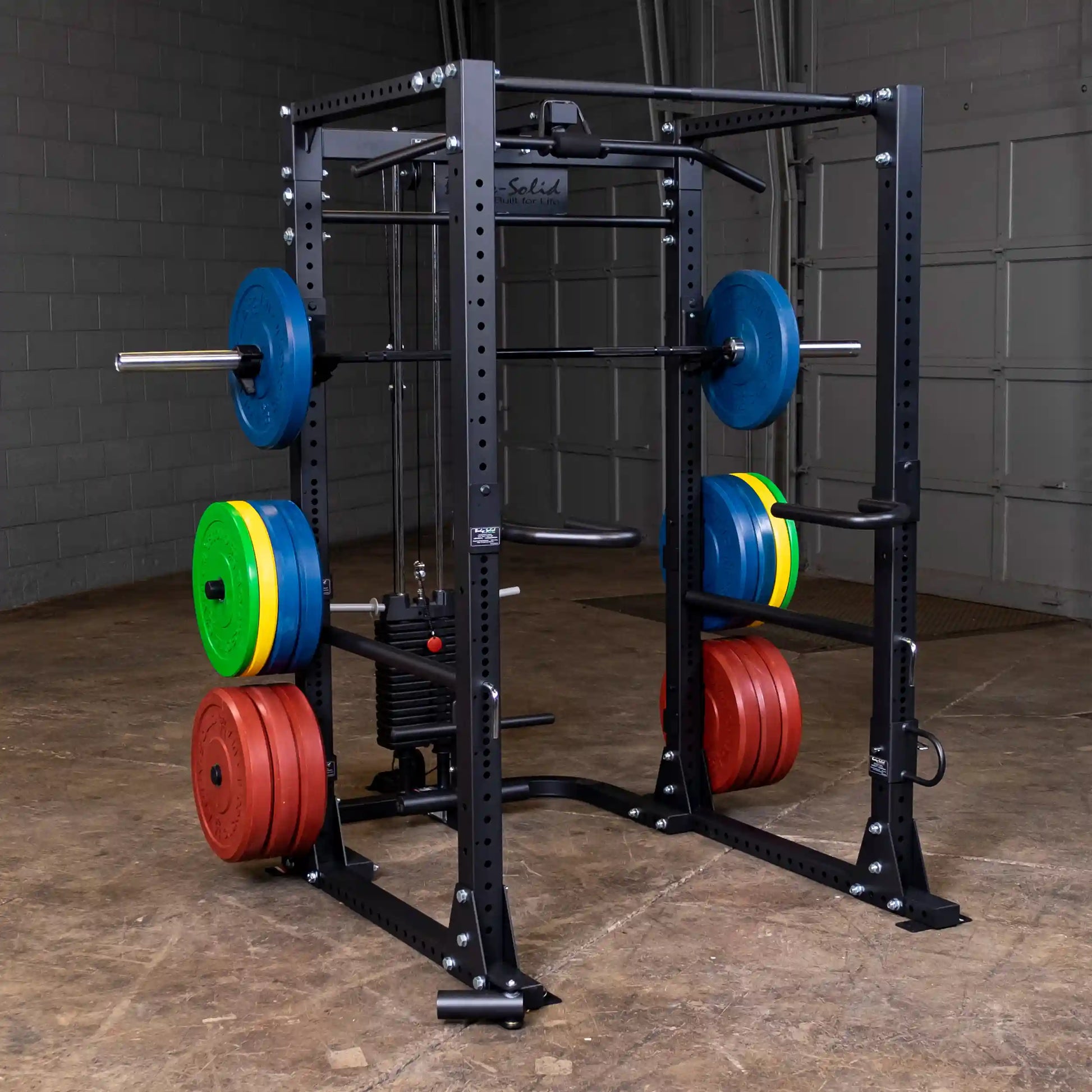 Power rack with colorful weight plates and steel frame for strength training.