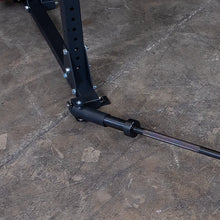 Landmine attachment on a black power rack for weightlifting.