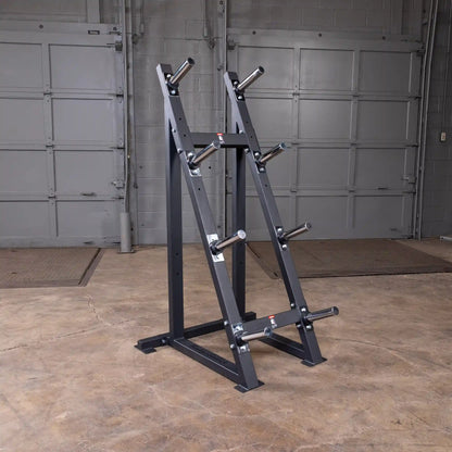Steel weight plate tree in a gym with multiple storage pegs for organized weightlifting equipment.