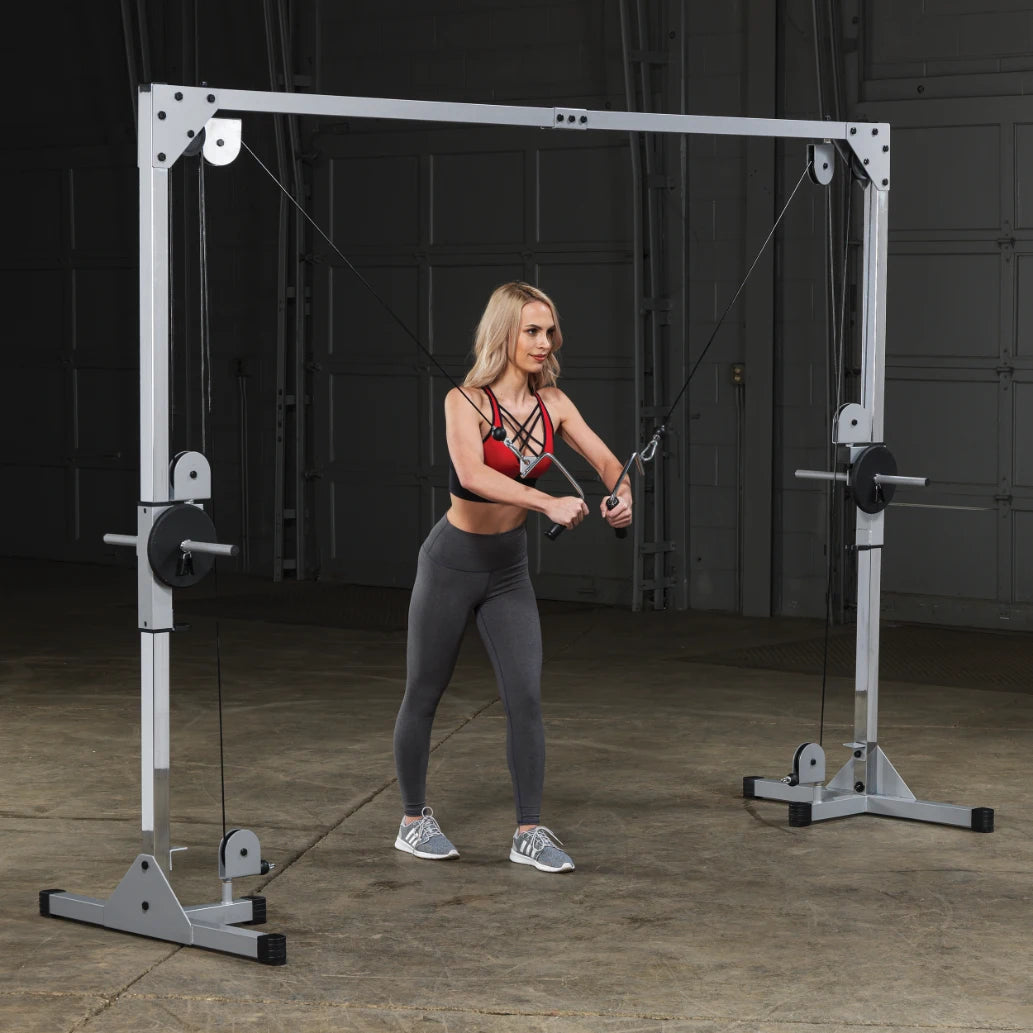 A person using a cable machine for strength training, performing a cable exercise in a gym setting, wearing athletic clothing.