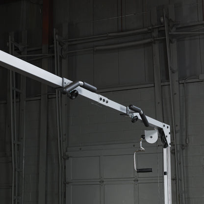 Close-up of a gym cable machine showing the pulley system and handle, set against a dark industrial background.