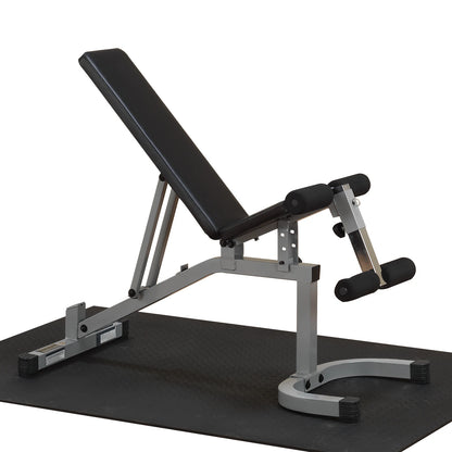 Adjustable weight bench with a black padded seat and gray metal frame, positioned on a black rubber gym mat.