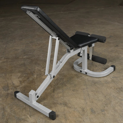 Adjustable weight bench with a black padded seat and backrest, featuring a silver frame and rubber feet, positioned on a concrete floor.