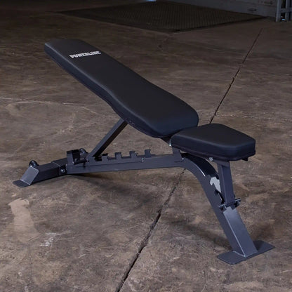 Adjustable weight bench with a black padded seat and backrest, set against a concrete floor. The bench is branded POWERLINE.