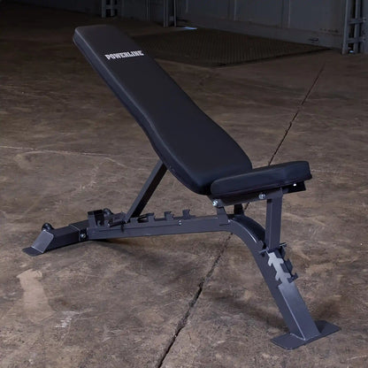 Adjustable weight bench with a black padded seat and backrest, featuring the brand name POWERLINE, set against a concrete floor.