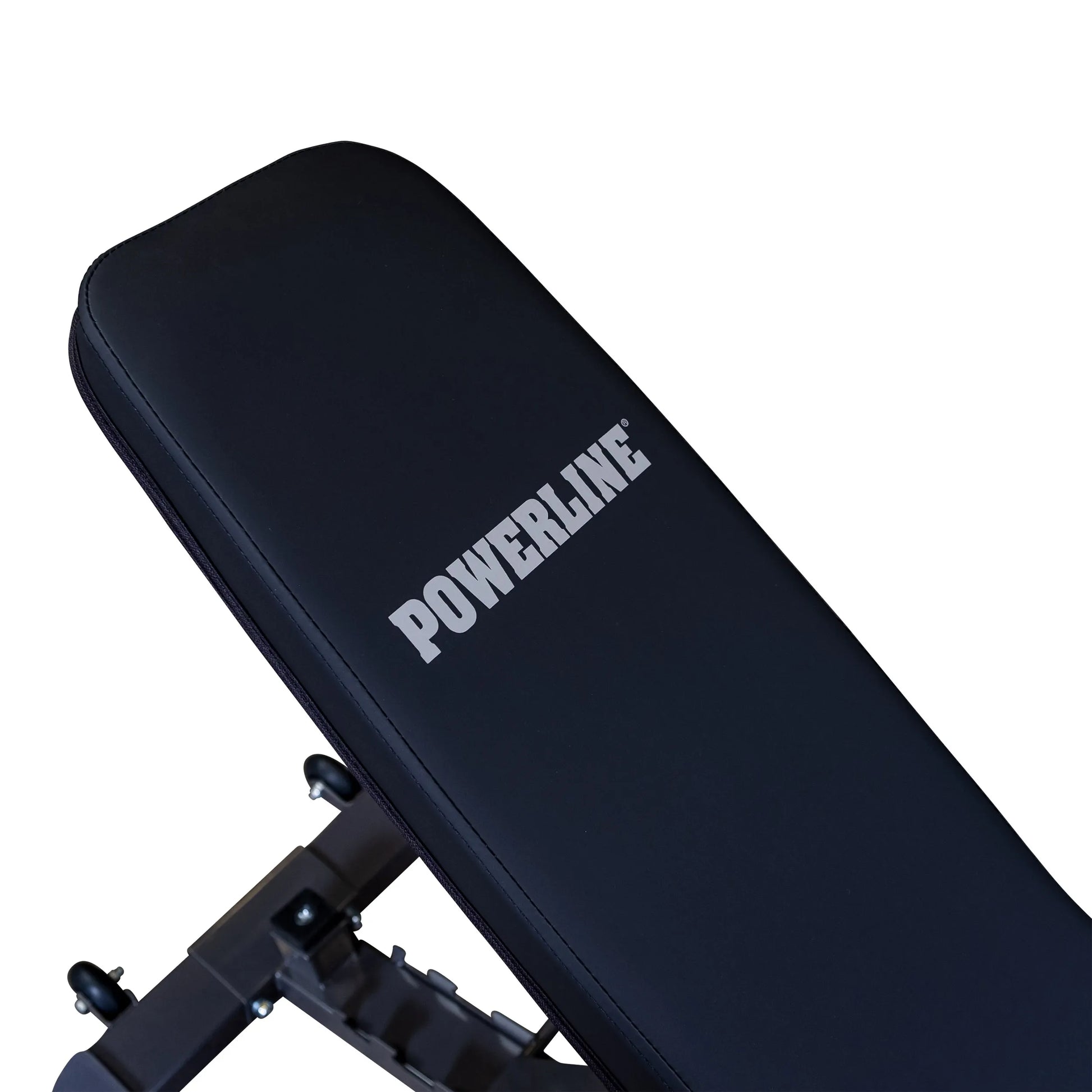Close-up of a black workout bench with the logo 'POWERLINE' prominently displayed on the padded surface.