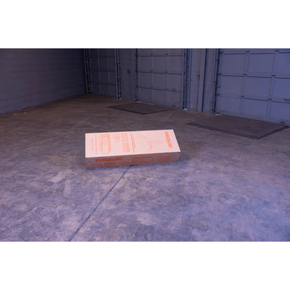 A large, flat cardboard box labeled 'POWERLINE' resting on a concrete floor in an empty garage space with gray walls and open garage doors in the background.