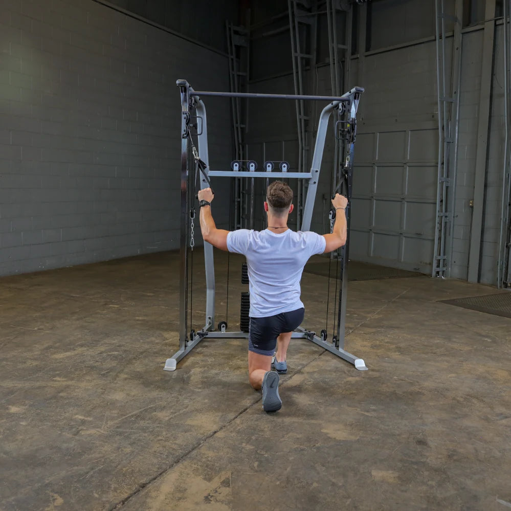 A person performing a kneeling exercise using a cable machine in a gym setting, with a focus on strength training.