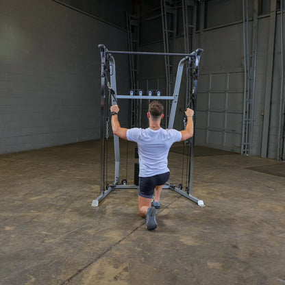 A person performing a kneeling exercise using a cable machine in a gym setting, with a focus on strength training.