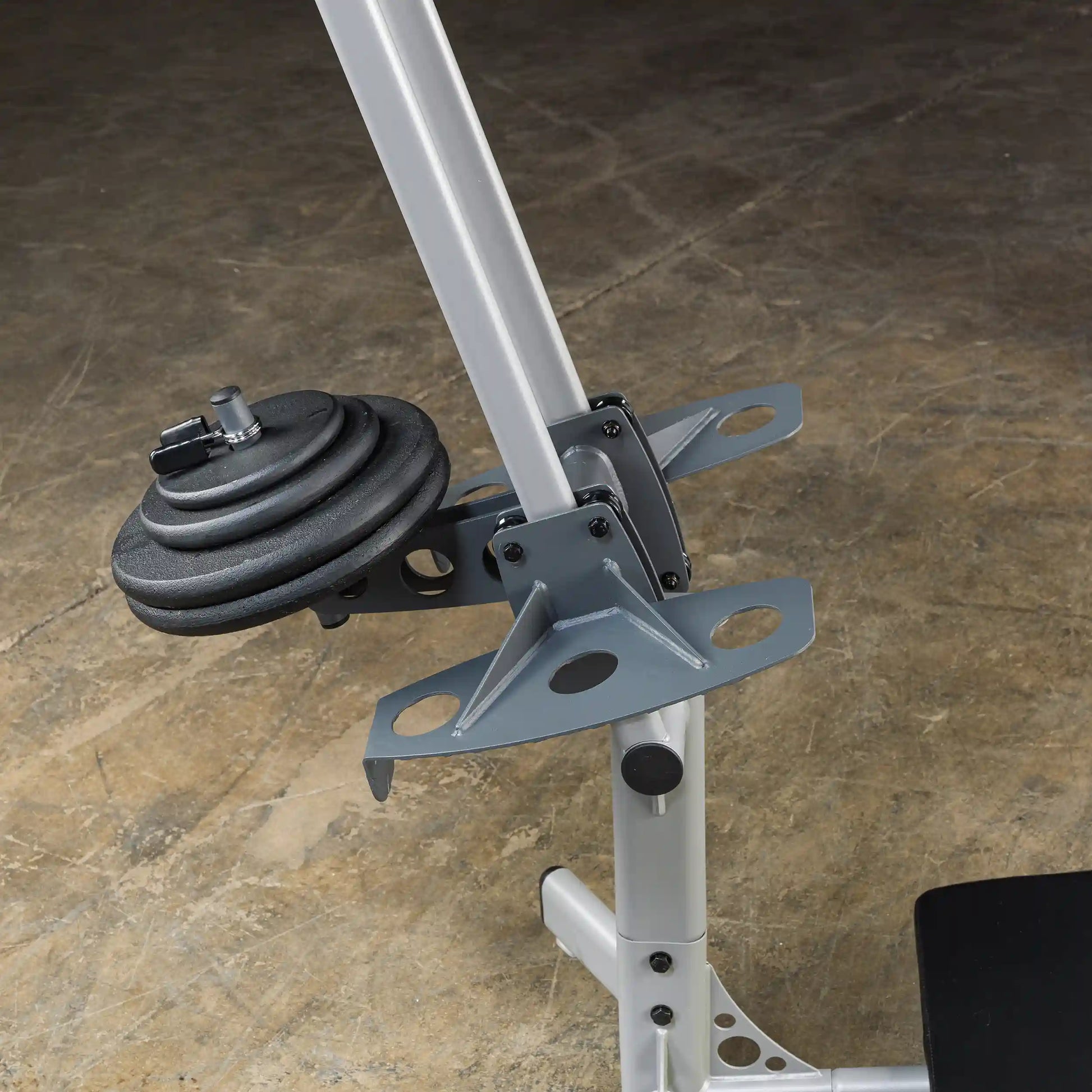 Close-up of a weight plate attached to a weightlifting machine, showcasing the adjustable mechanism and sturdy metal frame.