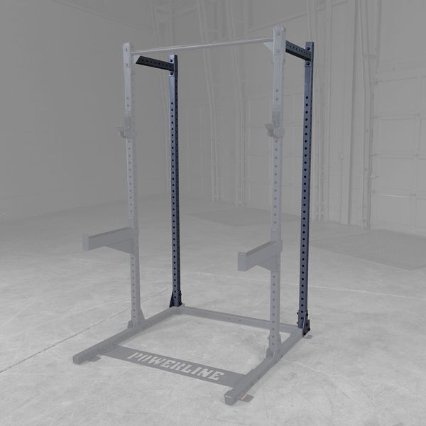 Powerline squat rack with a gray background, featuring adjustable arms and a sturdy frame, designed for strength training exercises.