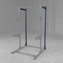 Powerline squat rack with a gray background, featuring adjustable arms and a sturdy frame, designed for strength training exercises.