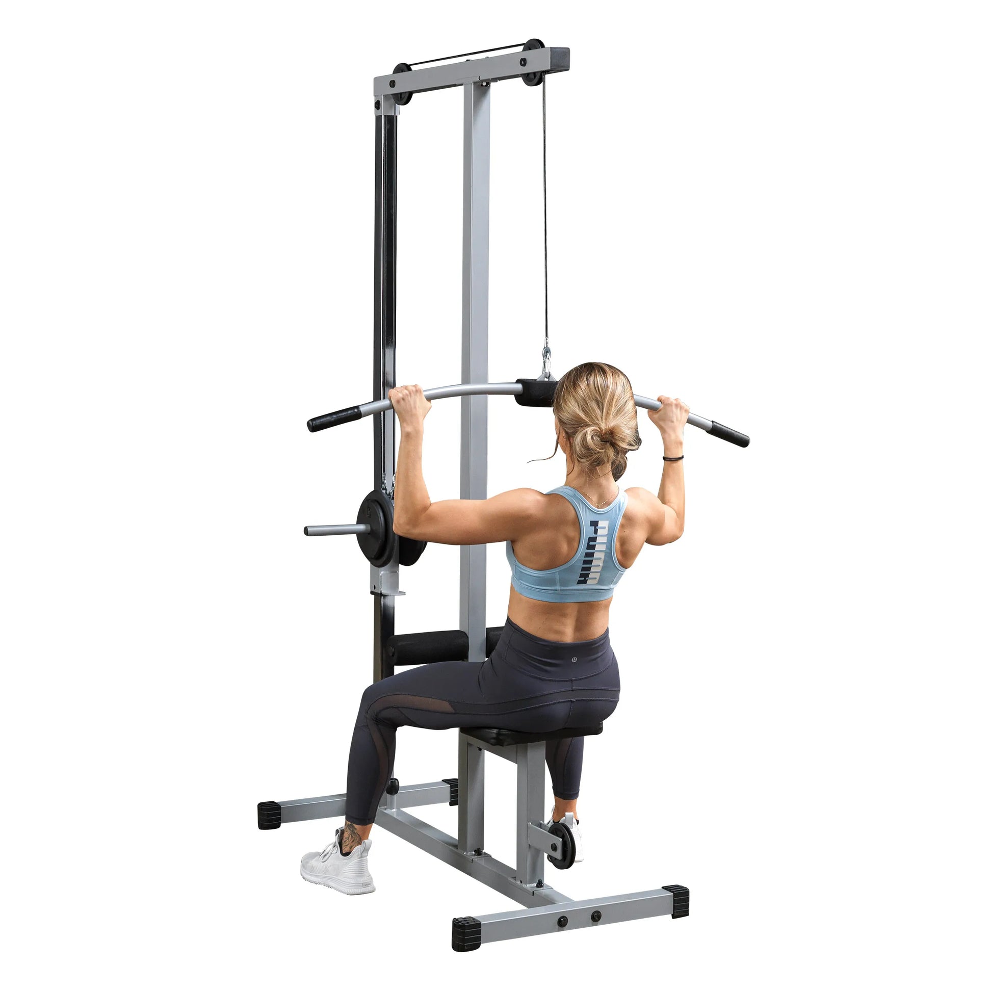 A person performing a lat pulldown exercise on a gym machine, wearing a light blue sports bra and black leggings, with a focus on their back and arms.