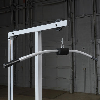 Close-up view of a gym cable machine with a curved handlebar attachment, designed for strength training, set against a dark background.