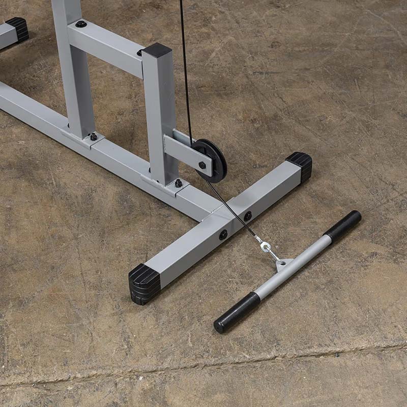 Cable machine pulley system with a black handle on a gray metal frame for home gym.