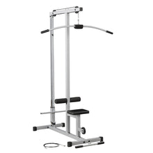 A silver and black cable machine for strength training, featuring a curved handle, adjustable seat, and padded rollers, with a cable lying on the floor beside it.